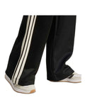 Adidas Stadium Stripes Tracksuit Bottoms in black with signature 3-Stripes, soft recycled polyester-cotton blend, satin piping, and matte rubber-print logo.