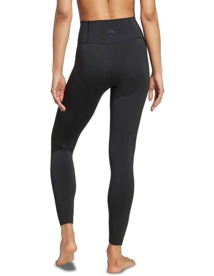 Person wearing black leggings on a white background