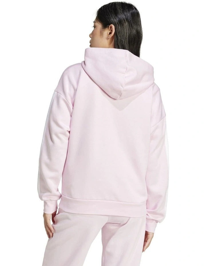 Person wearing a pink tracksuit on a white background