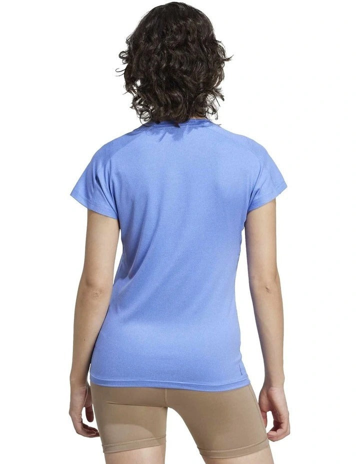 Person wearing a blue Adidas t-shirt on a white background