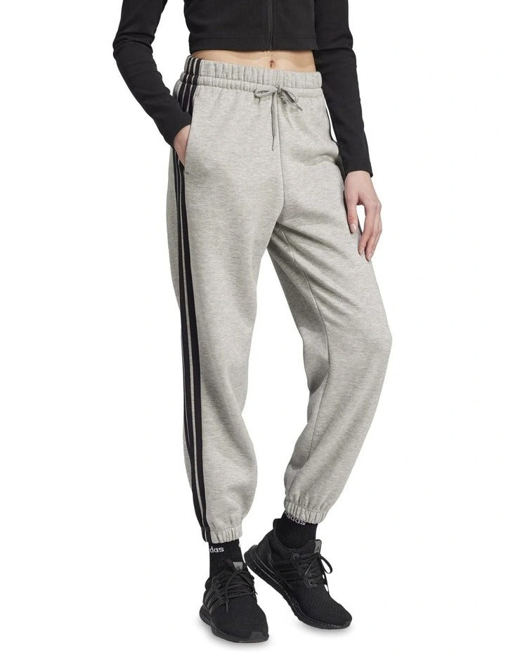 Adidas Essentials 3-Stripes Fleece Loose-Fit Joggers in grey, cozy casual pants with iconic side stripes, made from recycled cotton and polyester blend